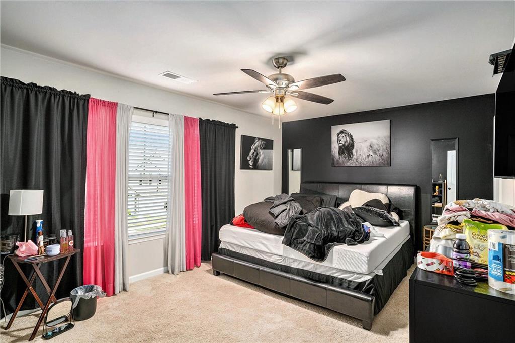 11940 Brightside Parkway Hampton, GA 30228 - Photo 14 of 31 a bed room with furniture and a flat screen tv