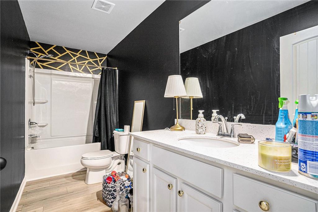 11940 Brightside Parkway Hampton, GA 30228 - Photo 16 of 31 a bathroom with a sink mirror vanity and toilet