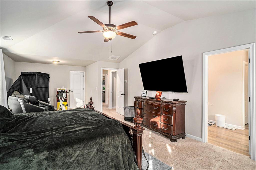 11940 Brightside Parkway Hampton, GA 30228 - Photo 20 of 31 a bedroom with bed tv and flat screen tv