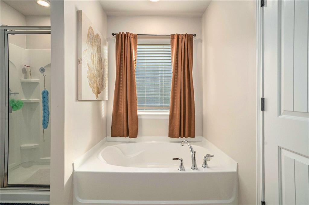 11940 Brightside Parkway Hampton, GA 30228 - Photo 23 of 31 a bathroom with a bathtub and a shower