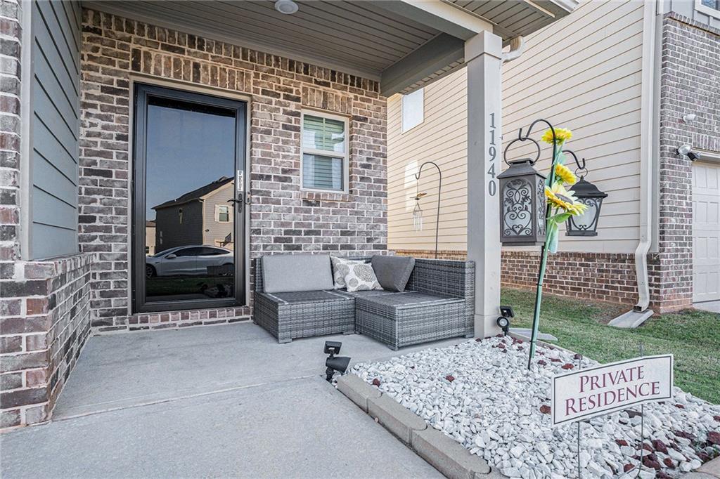 11940 Brightside Parkway Hampton, GA 30228 - Photo 4 of 31 a outdoor living space with patio furniture and a fireplace