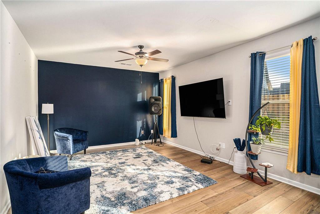 11940 Brightside Parkway Hampton, GA 30228 - Photo 7 of 31 a living room with furniture and a flat screen tv