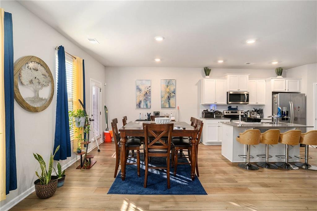 11940 Brightside Parkway Hampton, GA 30228 - Photo 9 of 31 a view of a dining room with furniture window and wooden floor