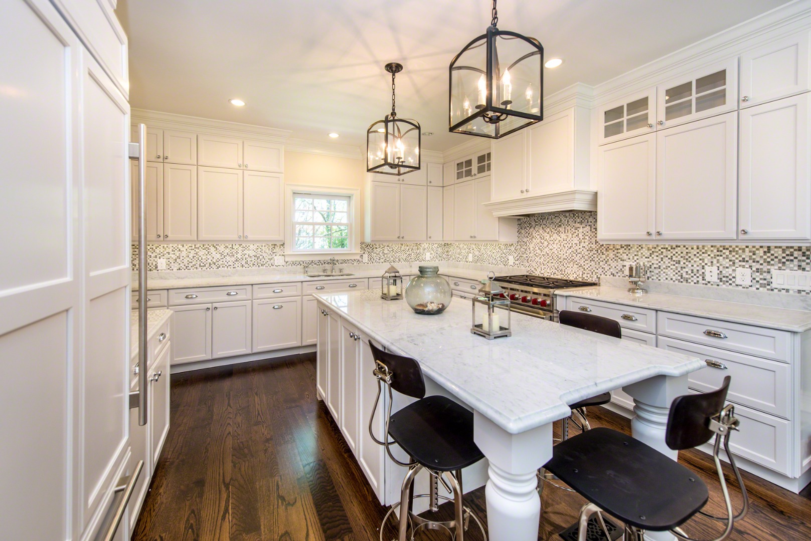 61 Clevelandtown Road Edgartown, MA 02539 - Photo 15 of 43 a kitchen with a dining table chairs sink and cabinets