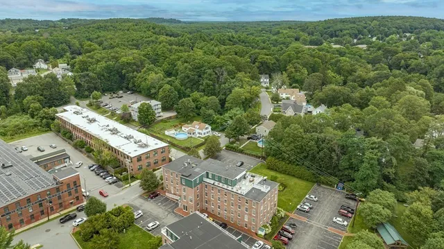 an aerial view of residential houses with outdoor space and seating area