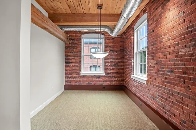 a view of a porch with a wooden floor and a window
