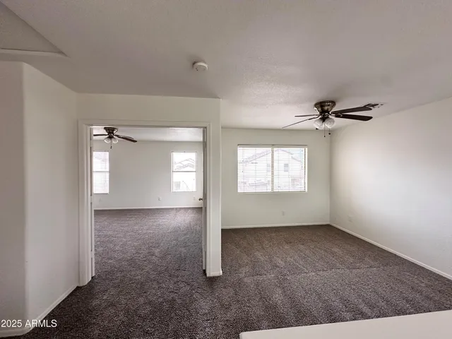 an empty room with windows and closet