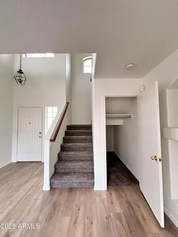 a view of a hallway with wooden floor and entryway