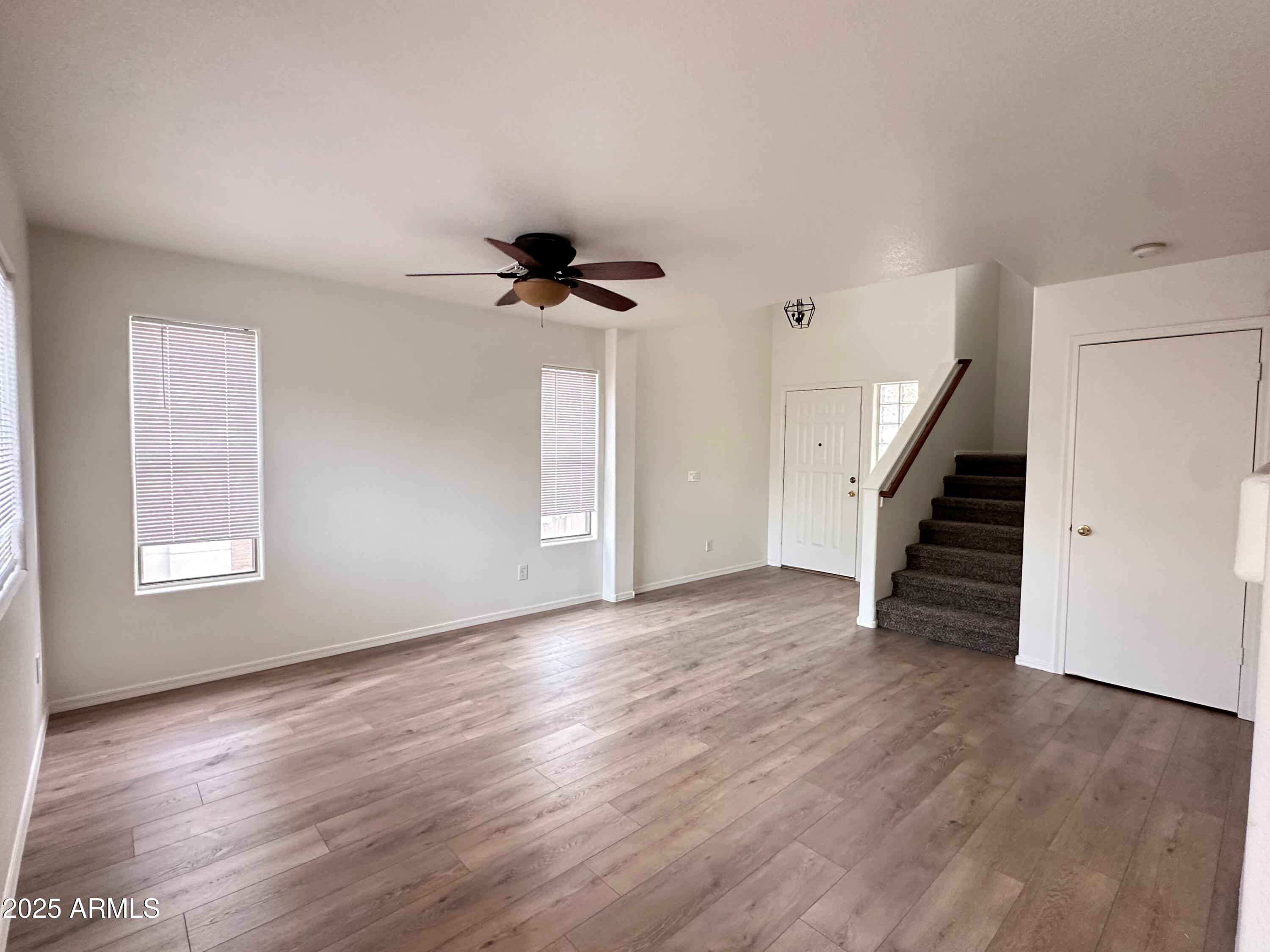 1782 East Del Rio Street Gilbert, AZ 85295 - Photo 7 of 23 a view of an empty room with wooden floor and a window