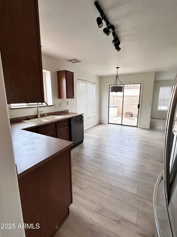a view of kitchen with sink microwave and refrigerator