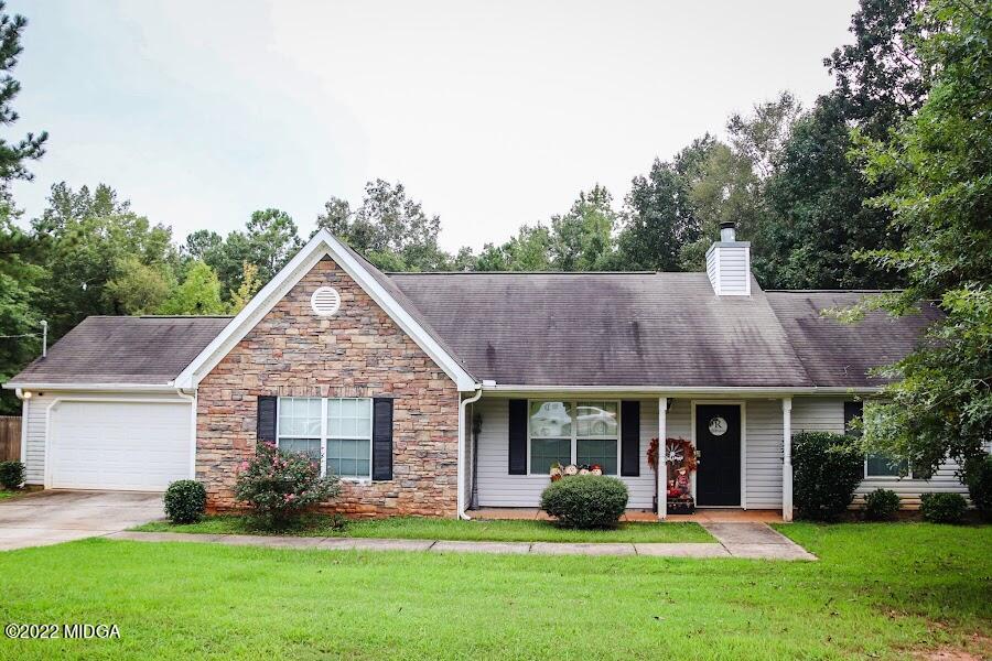 3336 Trotters Ridge Trail Gray, GA 31032 - Photo 1 of 16 a front view of a house with garden