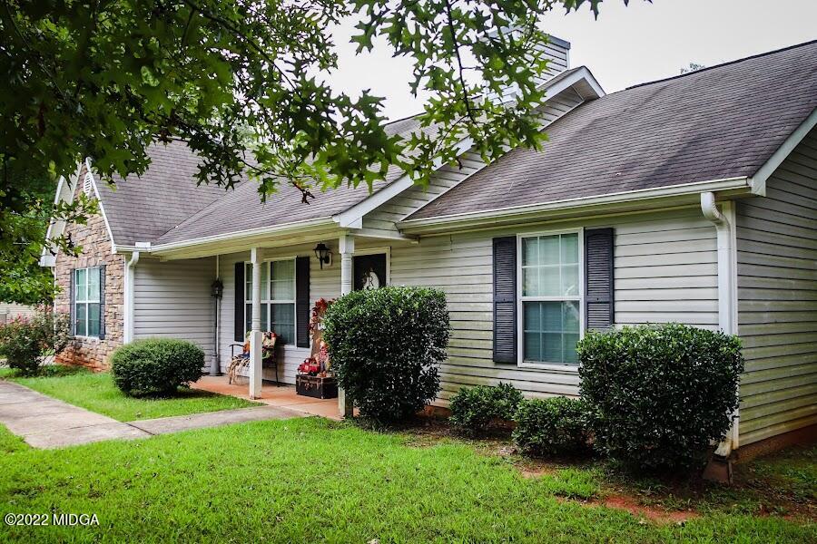 3336 Trotters Ridge Trail Gray, GA 31032 - Photo 3 of 16 a view of a house with a yard plants and a table and chairs