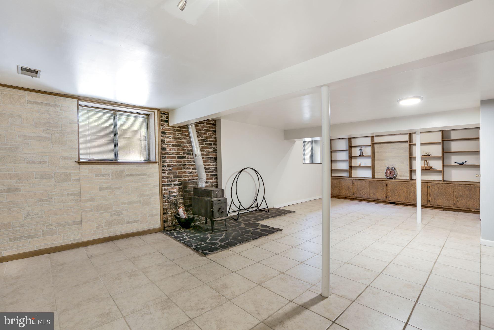 2233 Sanibel Drive Reston, VA 20191 - Photo 22 of 34 recreation room with old wood stove and shelves