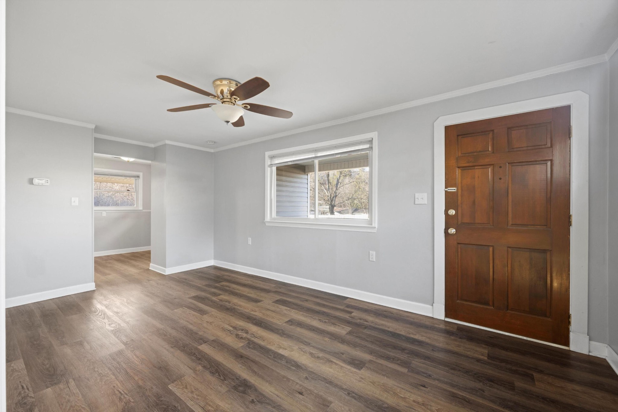420 West Cloud Springs Road Rossville, GA 30741 - Photo 5 of 16 an empty room with wooden floor ceiling fan and windows