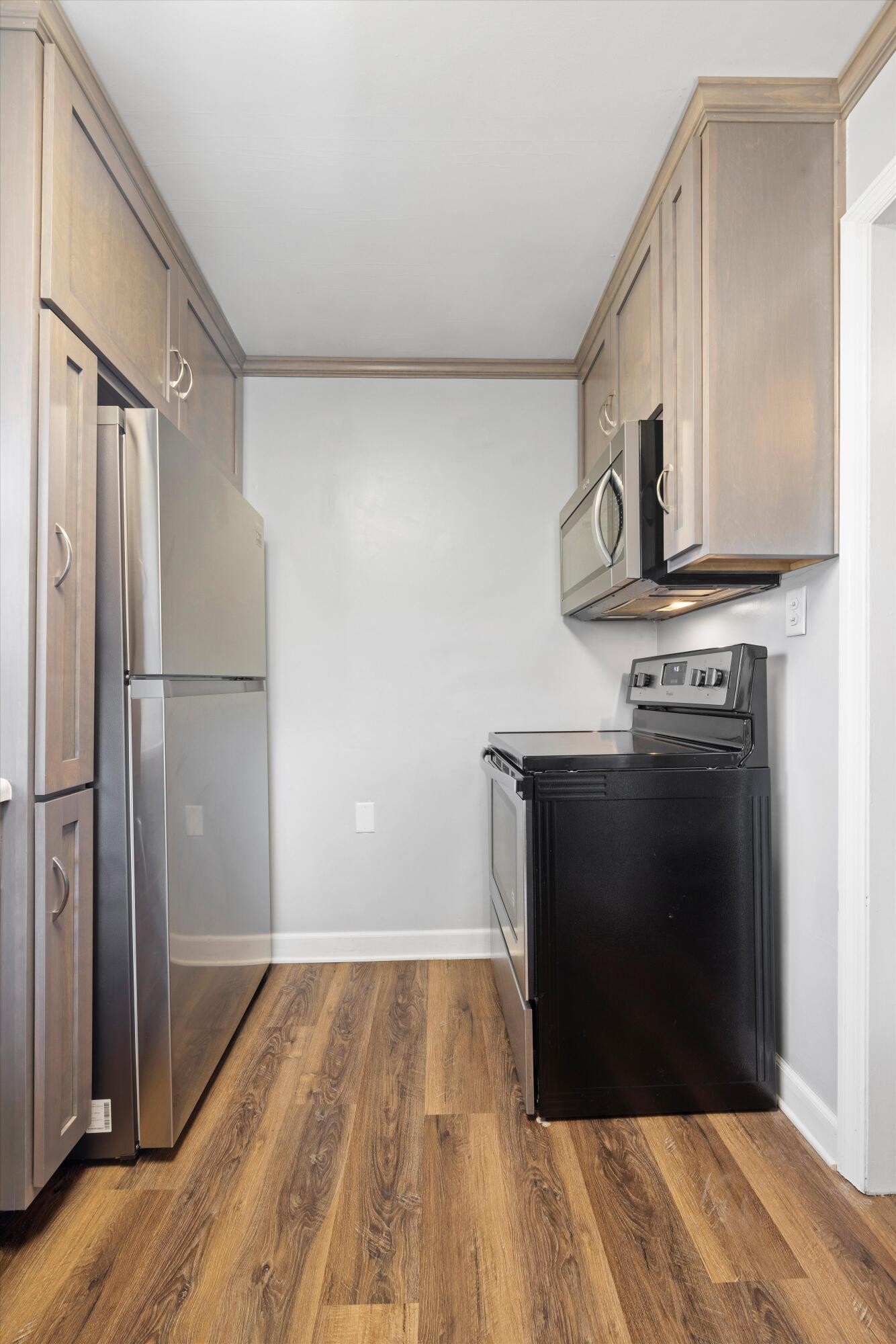420 West Cloud Springs Road Rossville, GA 30741 - Photo 8 of 16 a kitchen with a refrigerator and a wooden floor