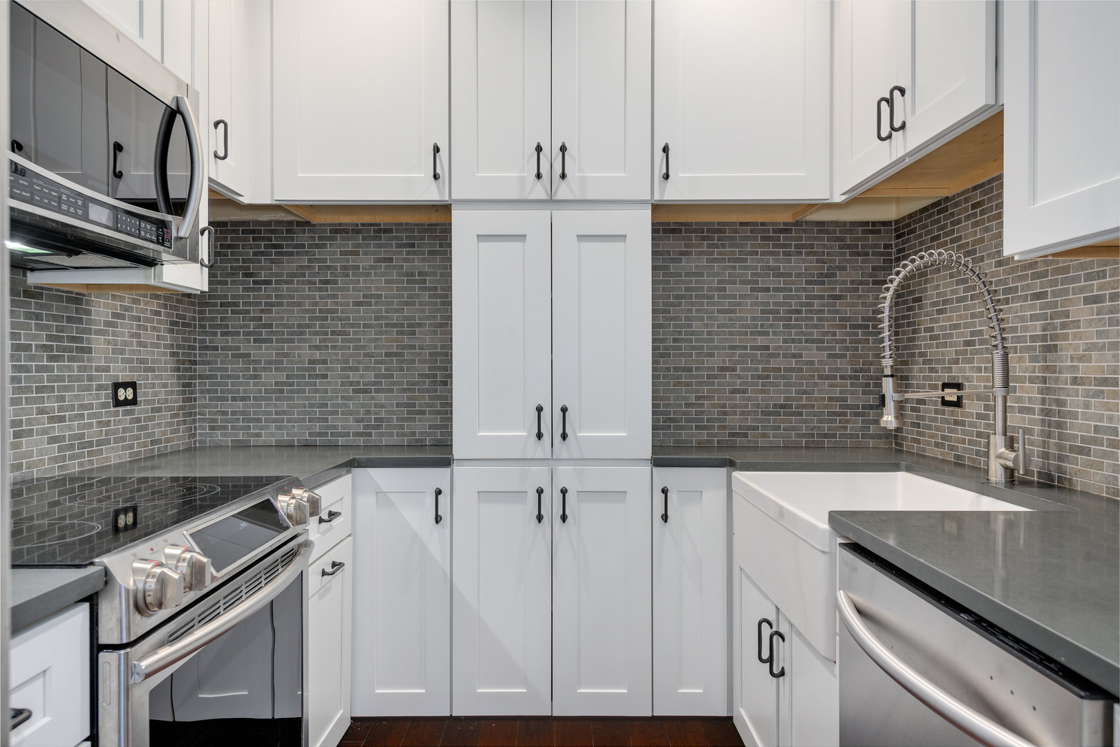 640 South Federal Street, Unit 708 Chicago, IL 60605 - Photo 11 of 20 a view of a kitchen with granite countertop white cabinets and white appliances