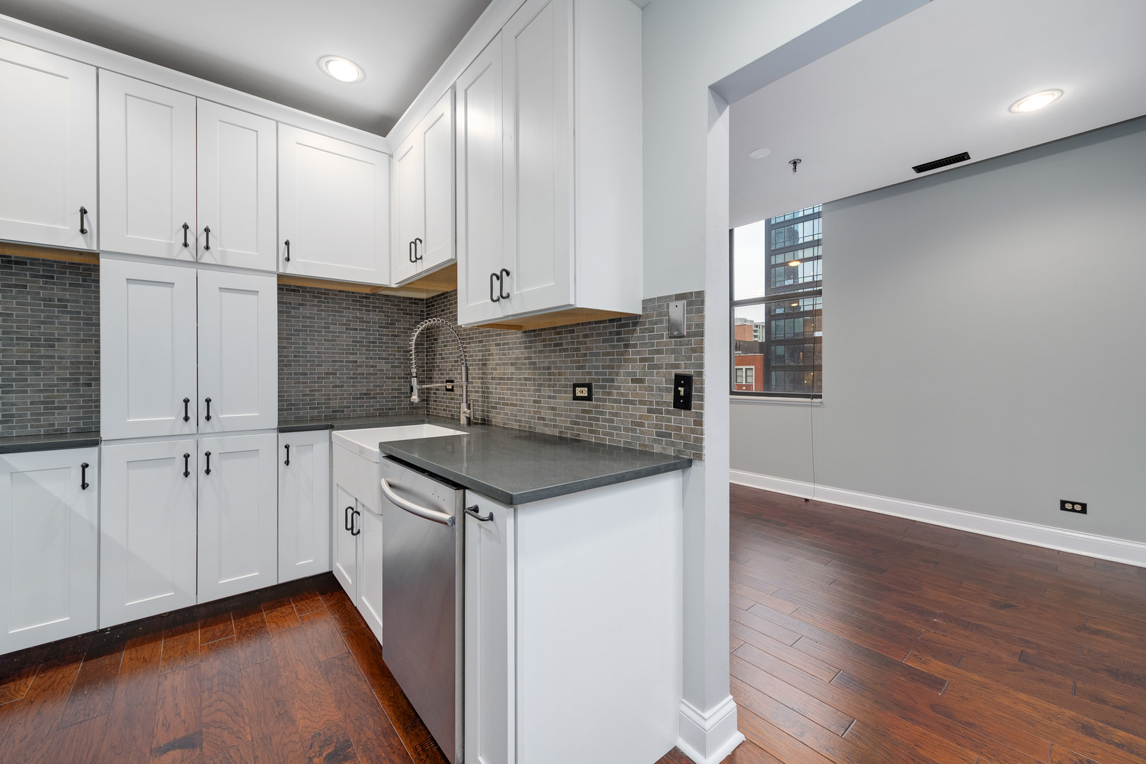 640 South Federal Street, Unit 708 Chicago, IL 60605 - Photo 13 of 20 a kitchen with white cabinets and sink