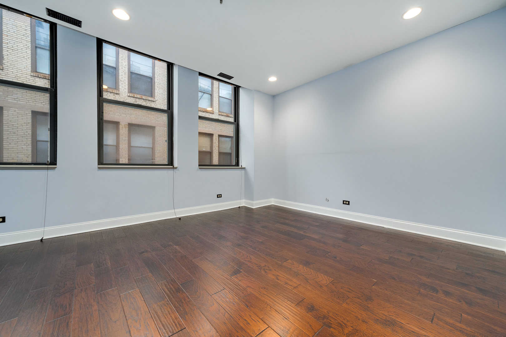 640 South Federal Street, Unit 708 Chicago, IL 60605 - Photo 16 of 20 a view of an empty room with wooden floor and entryway
