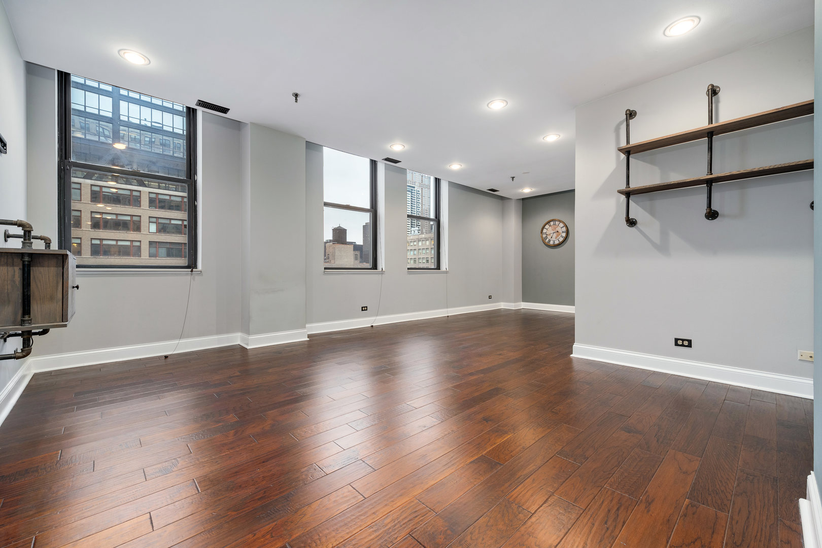 640 South Federal Street, Unit 708 Chicago, IL 60605 - Photo 4 of 20 an empty room with wooden floor and windows