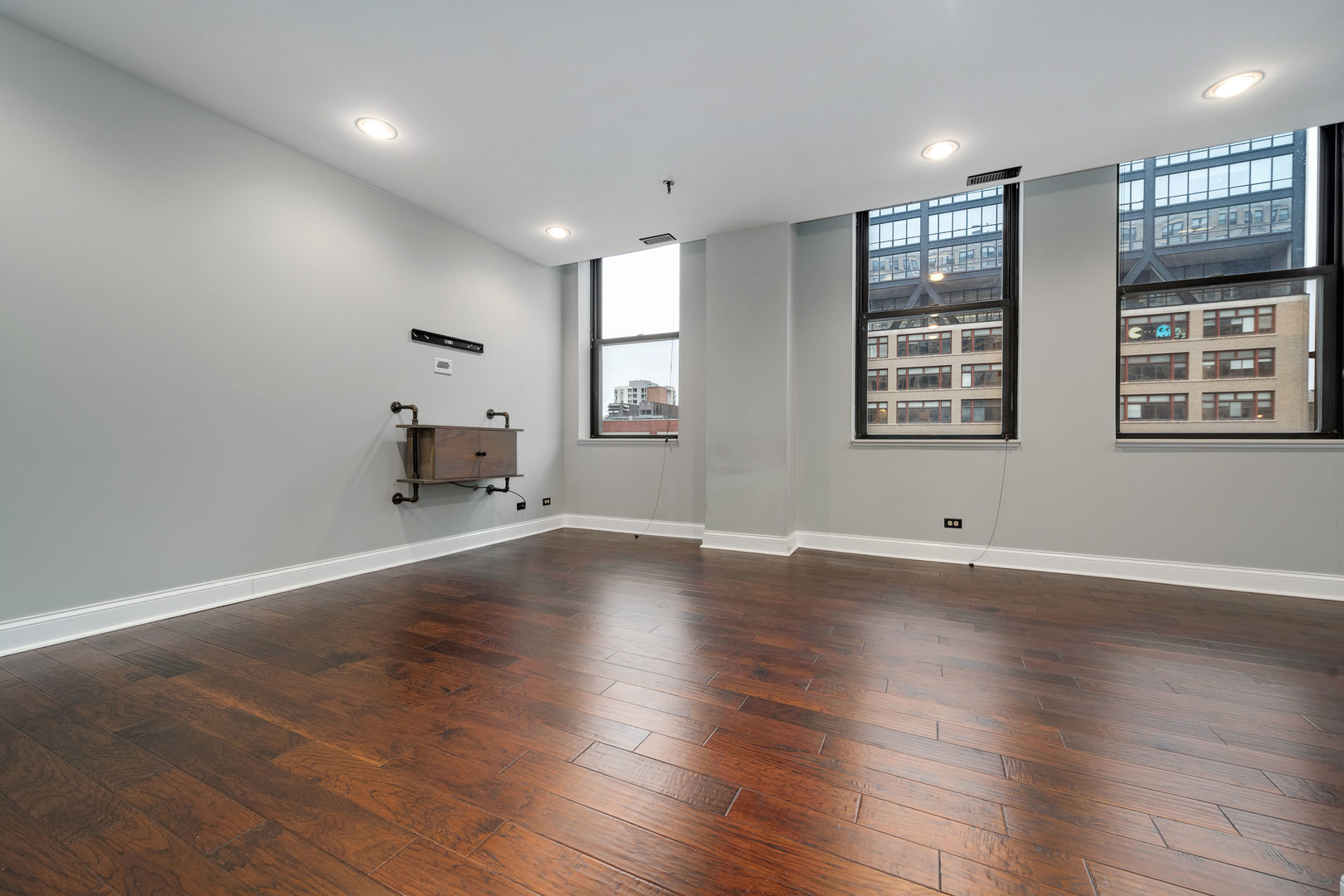 640 South Federal Street, Unit 708 Chicago, IL 60605 - Photo 8 of 20 an empty room with wooden floor and windows