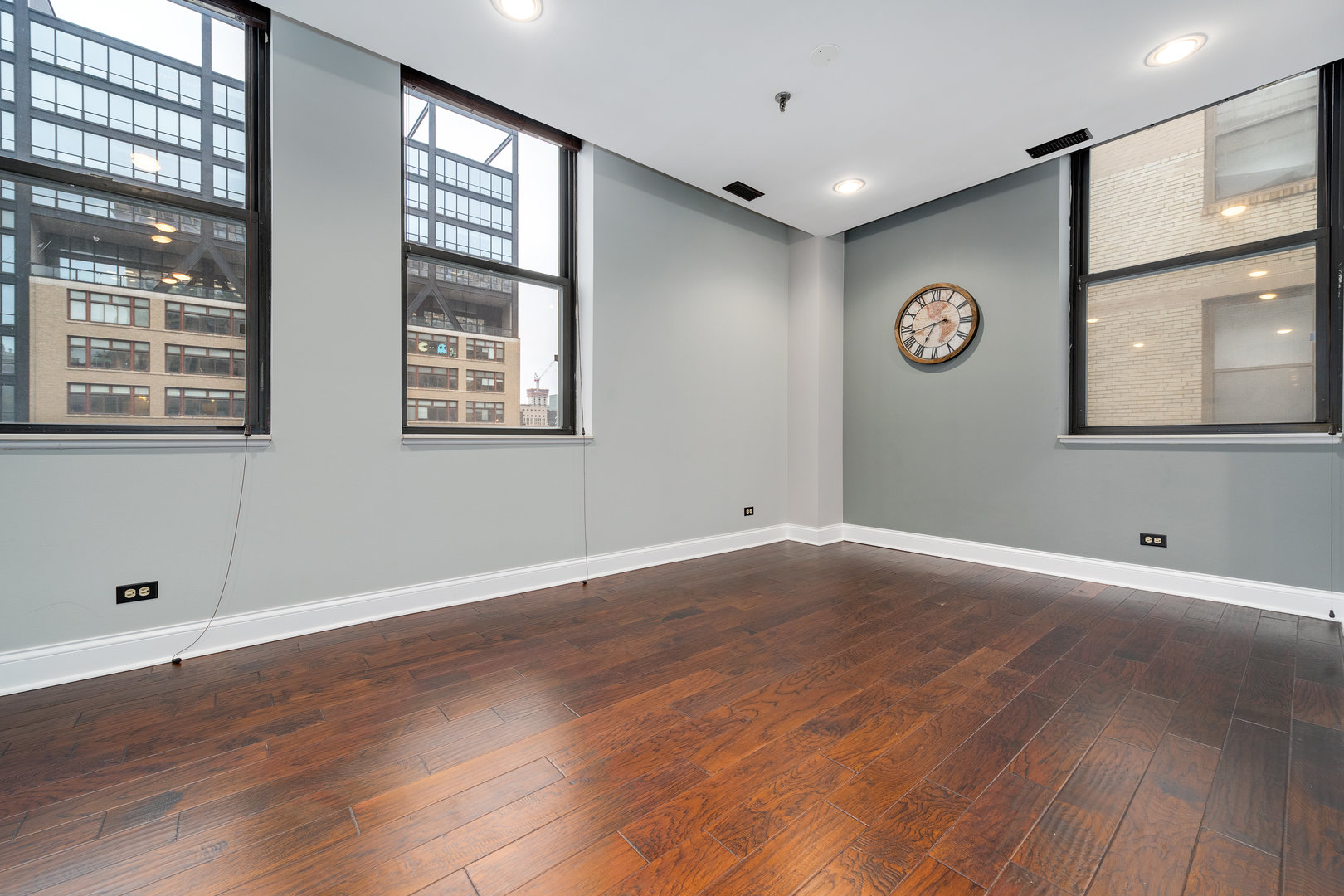 640 South Federal Street, Unit 708 Chicago, IL 60605 - Photo 10 of 20 a view of an empty room with wooden floor and windows