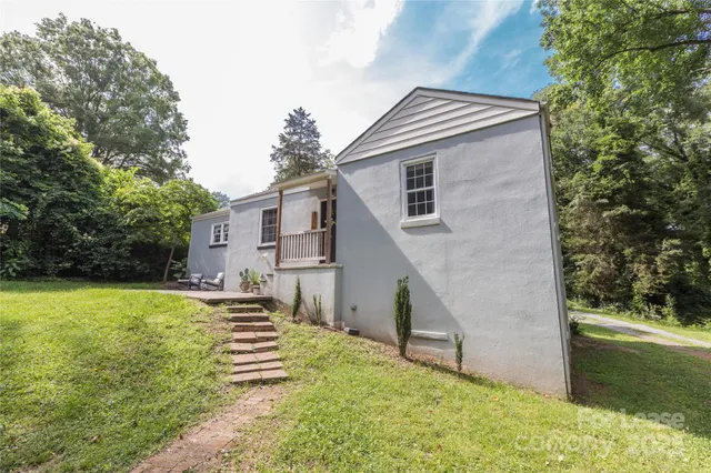 a backyard of a house with table and chairs