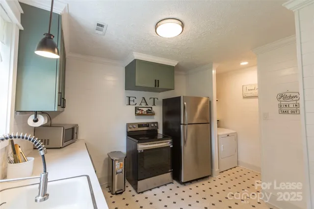 a kitchen with stainless steel appliances a refrigerator and a stove top oven