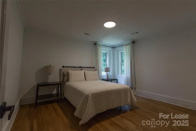 a bedroom with a bed and a night stand