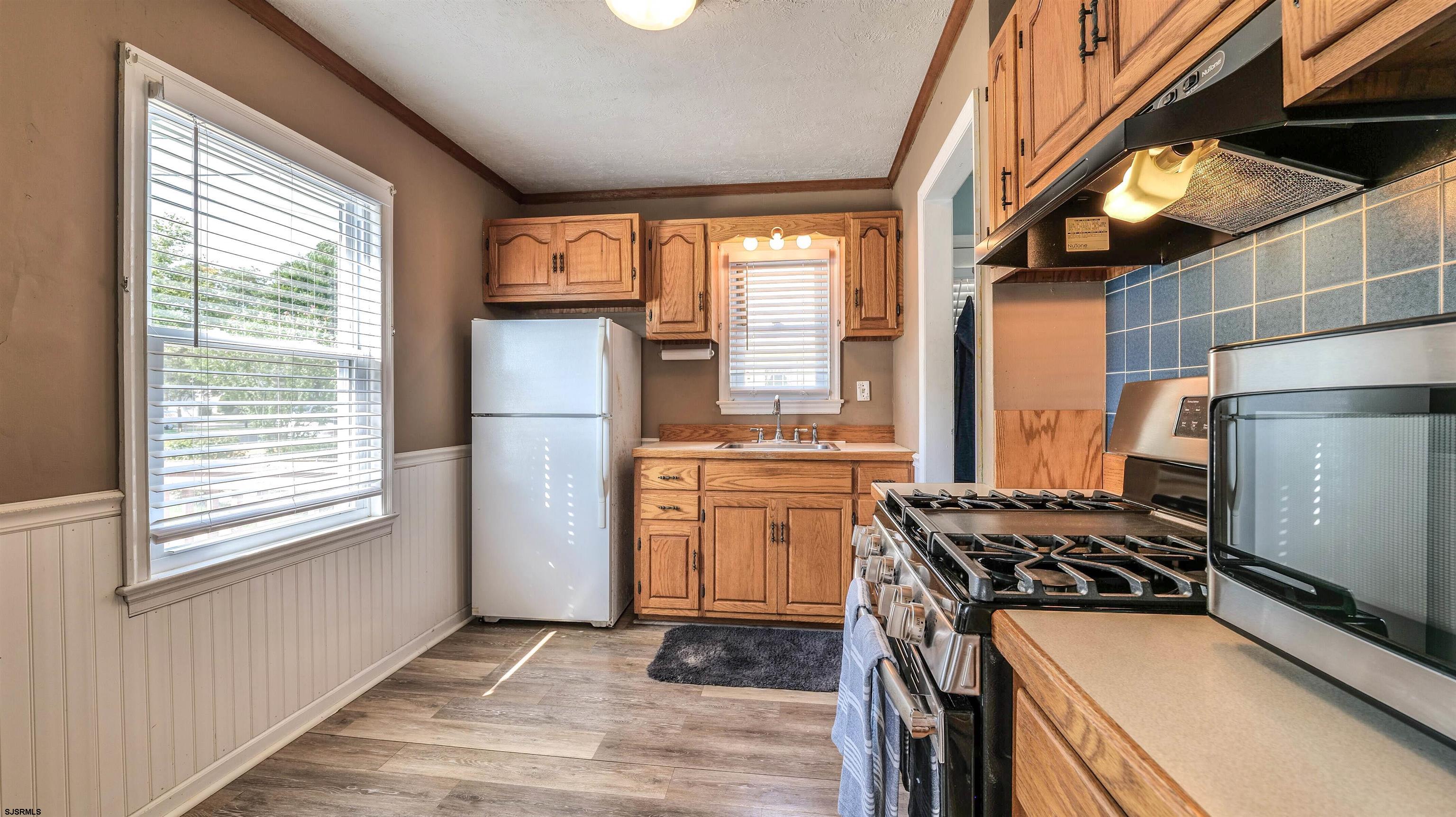 116 New Road Absecon, NJ 08201 - Photo 11 of 27 a kitchen with a stove a refrigerator and a stove