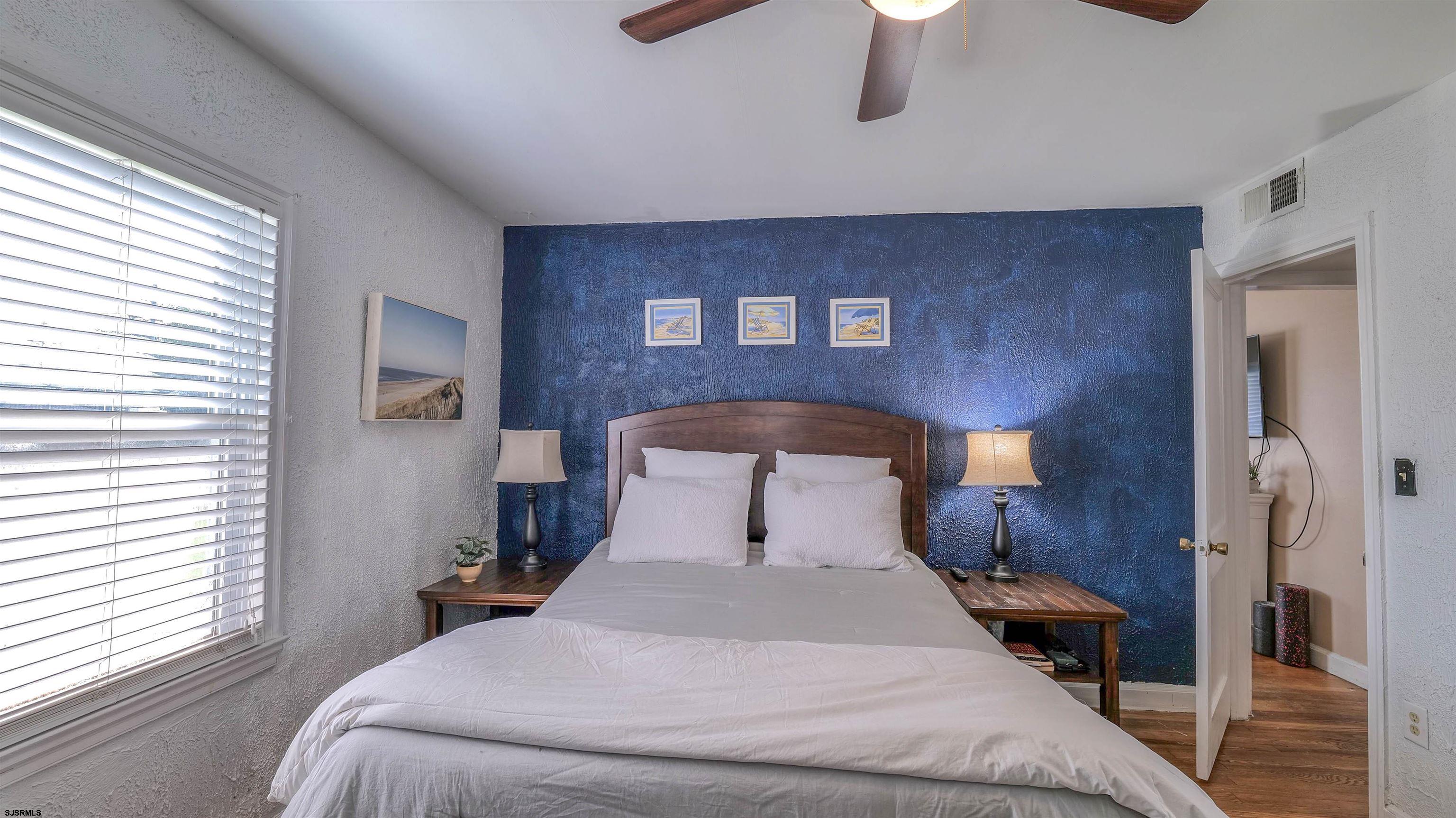 116 New Road Absecon, NJ 08201 - Photo 22 of 27 a bedroom with a bed and a lamp