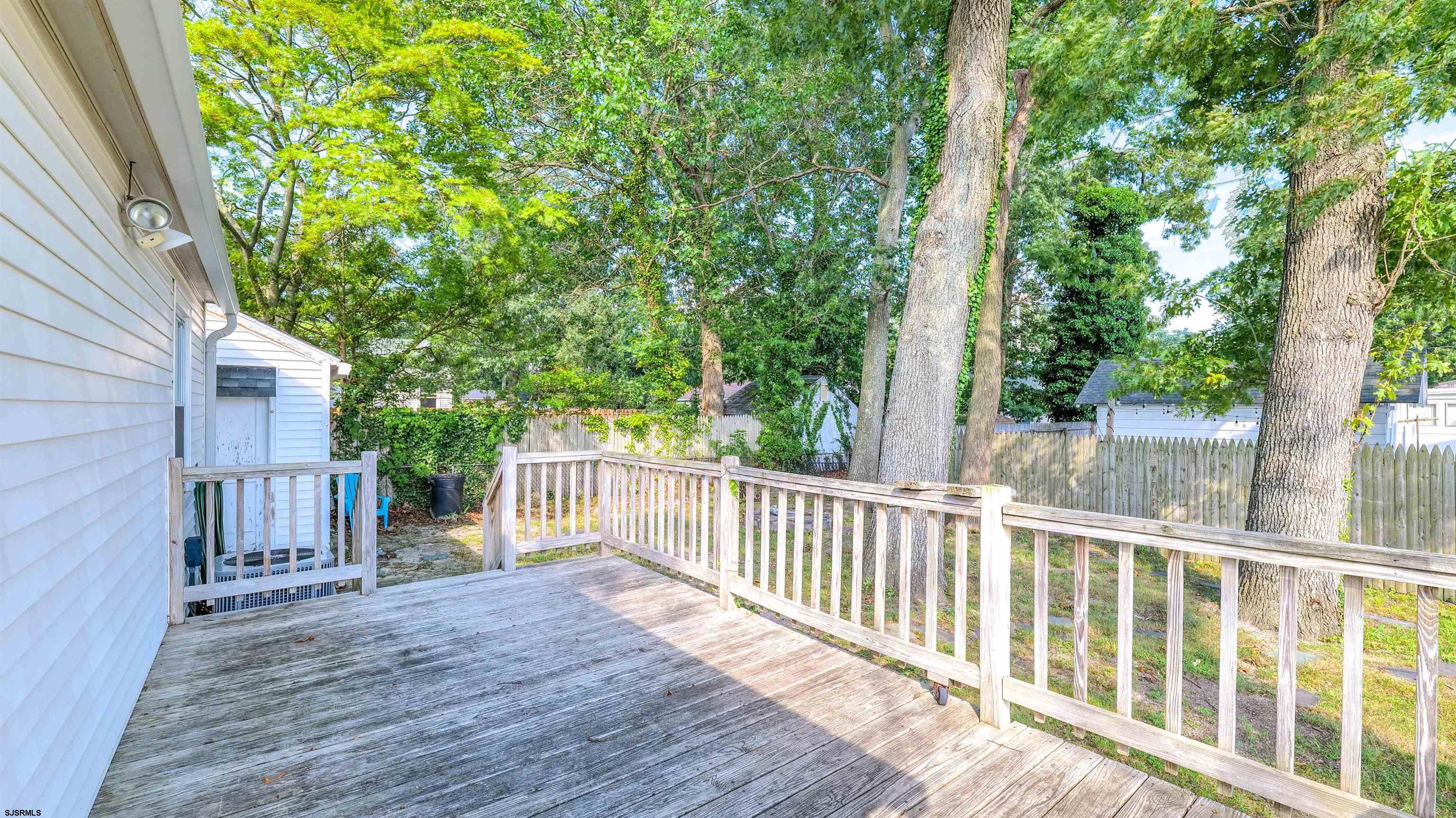 116 New Road Absecon, NJ 08201 - Photo 24 of 27 a view of a wooden deck next to a yard