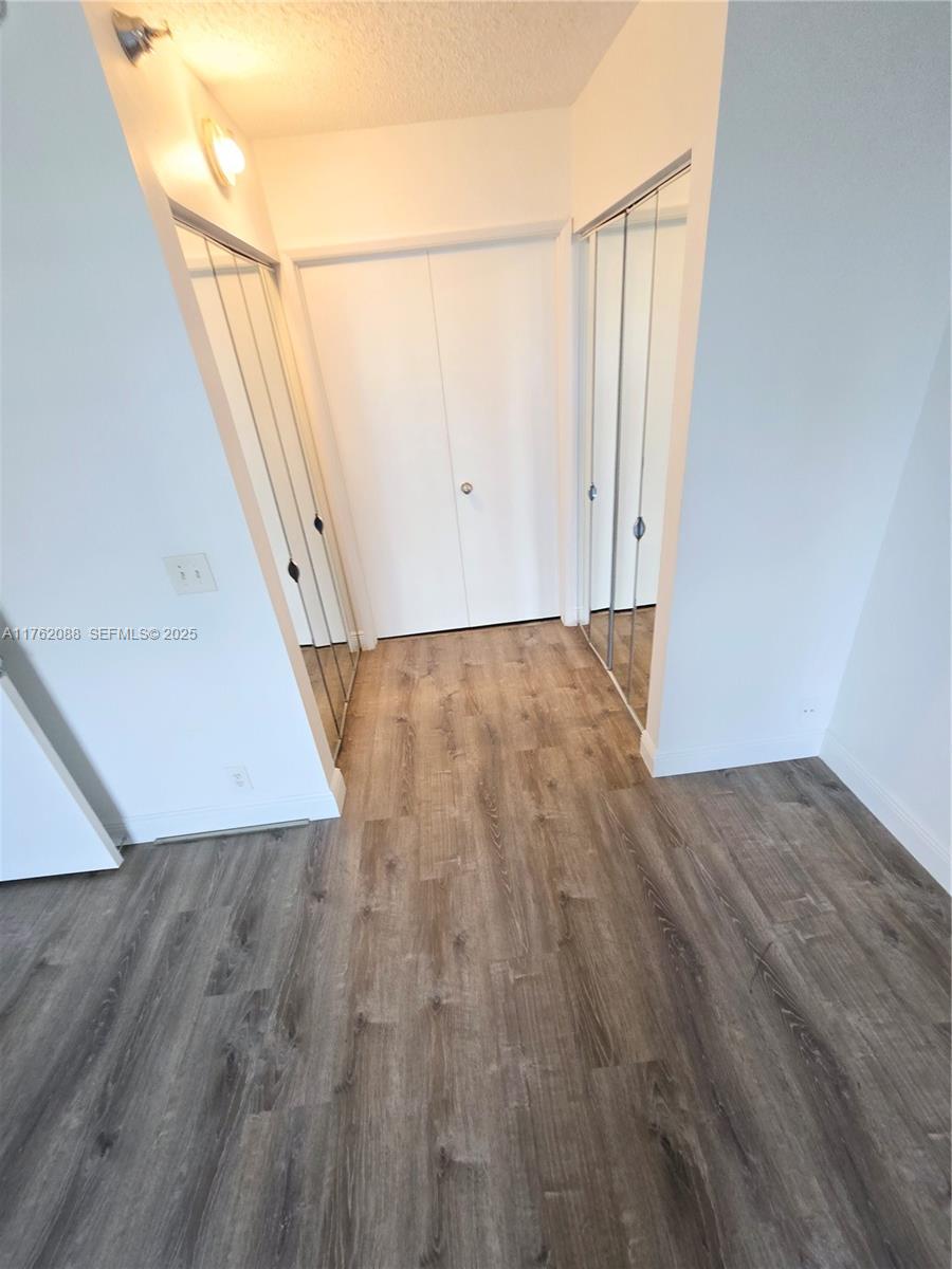 3300 Northeast 191st Street, Unit 609 Aventura, FL 33180 - Photo 11 of 16 an empty room with wooden floor