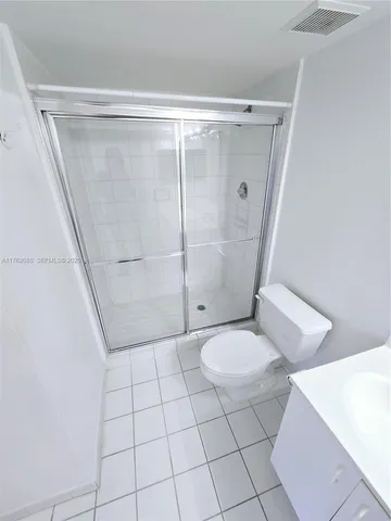 a bathroom with a shower and toilet