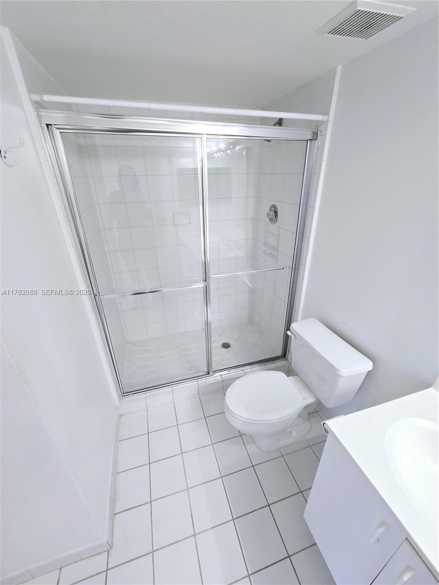 3300 Northeast 191st Street, Unit 609 Aventura, FL 33180 - Photo 12 of 16 a bathroom with a shower and toilet