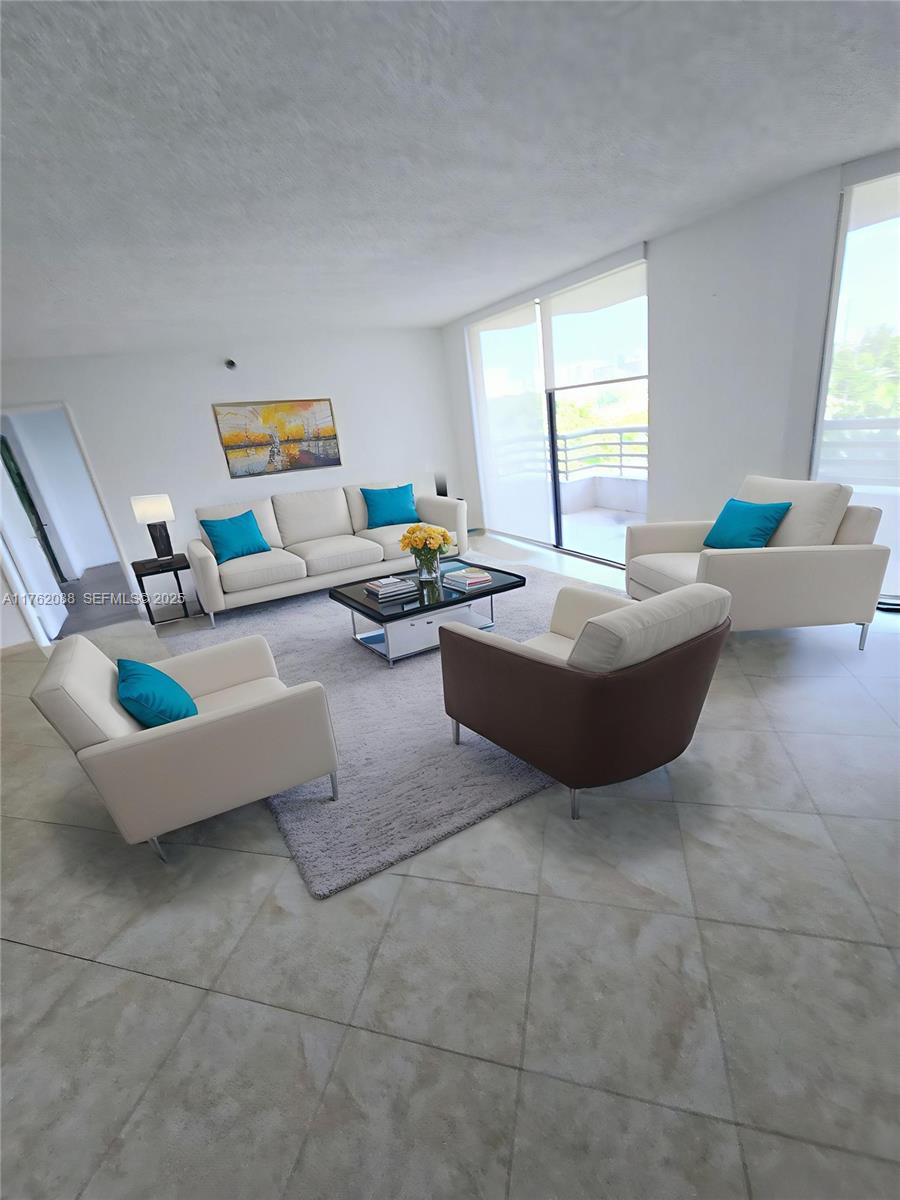 3300 Northeast 191st Street, Unit 609 Aventura, FL 33180 - Photo 2 of 16 a living room with couches and a coffee table