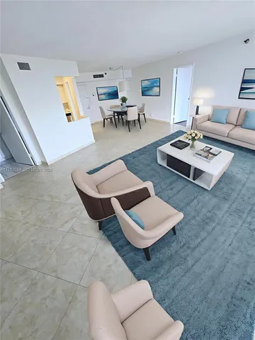 a living room with furniture and next to a window