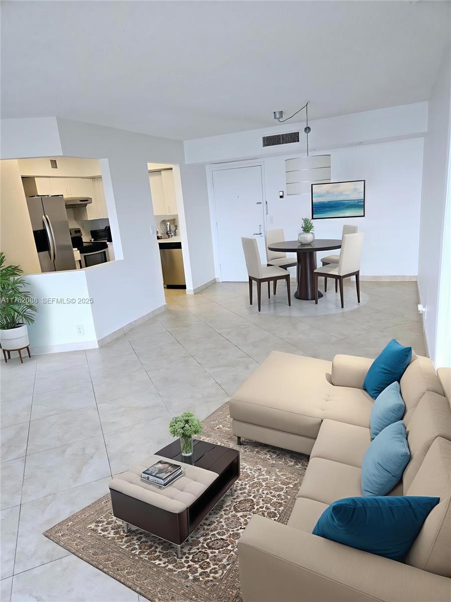 3300 Northeast 191st Street, Unit 609 Aventura, FL 33180 - Photo 4 of 16 a living room with furniture and a table