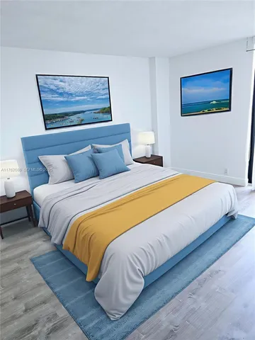 a bedroom with a bed and painting on the wall