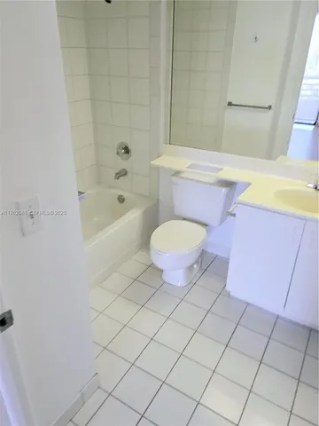 a bathroom with a sink a toilet a mirror and bathtub
