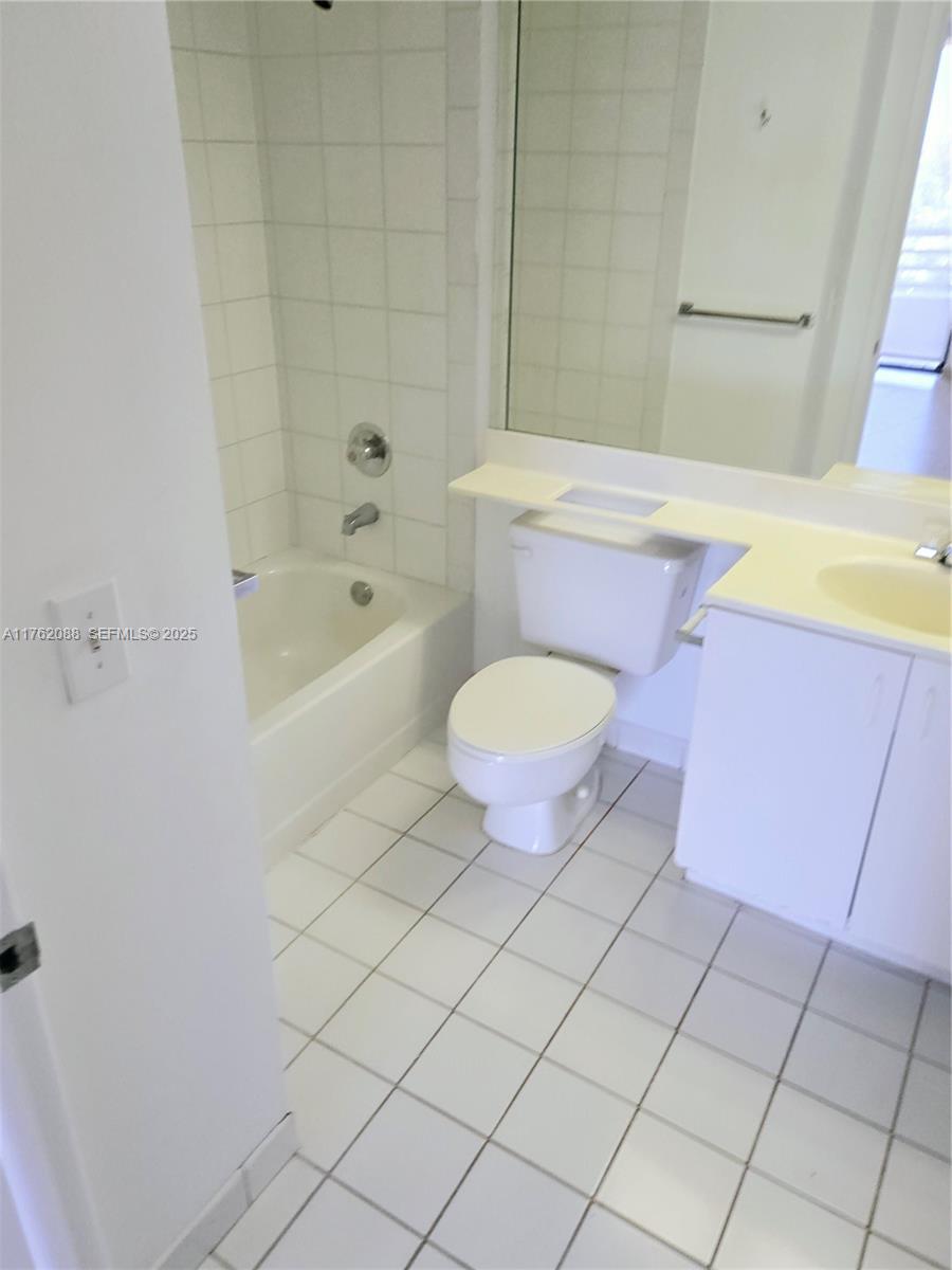 3300 Northeast 191st Street, Unit 609 Aventura, FL 33180 - Photo 10 of 16 a bathroom with a sink a toilet a mirror and bathtub