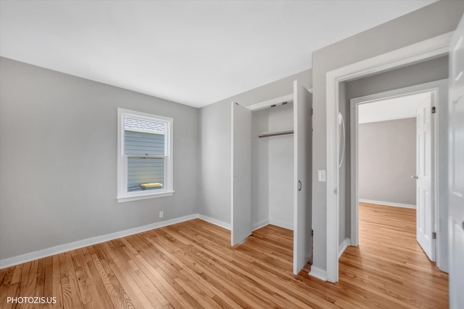 112 Pearl Street Cary, IL 60013 - Photo 11 of 25 a view of an empty room with wooden floor and a window
