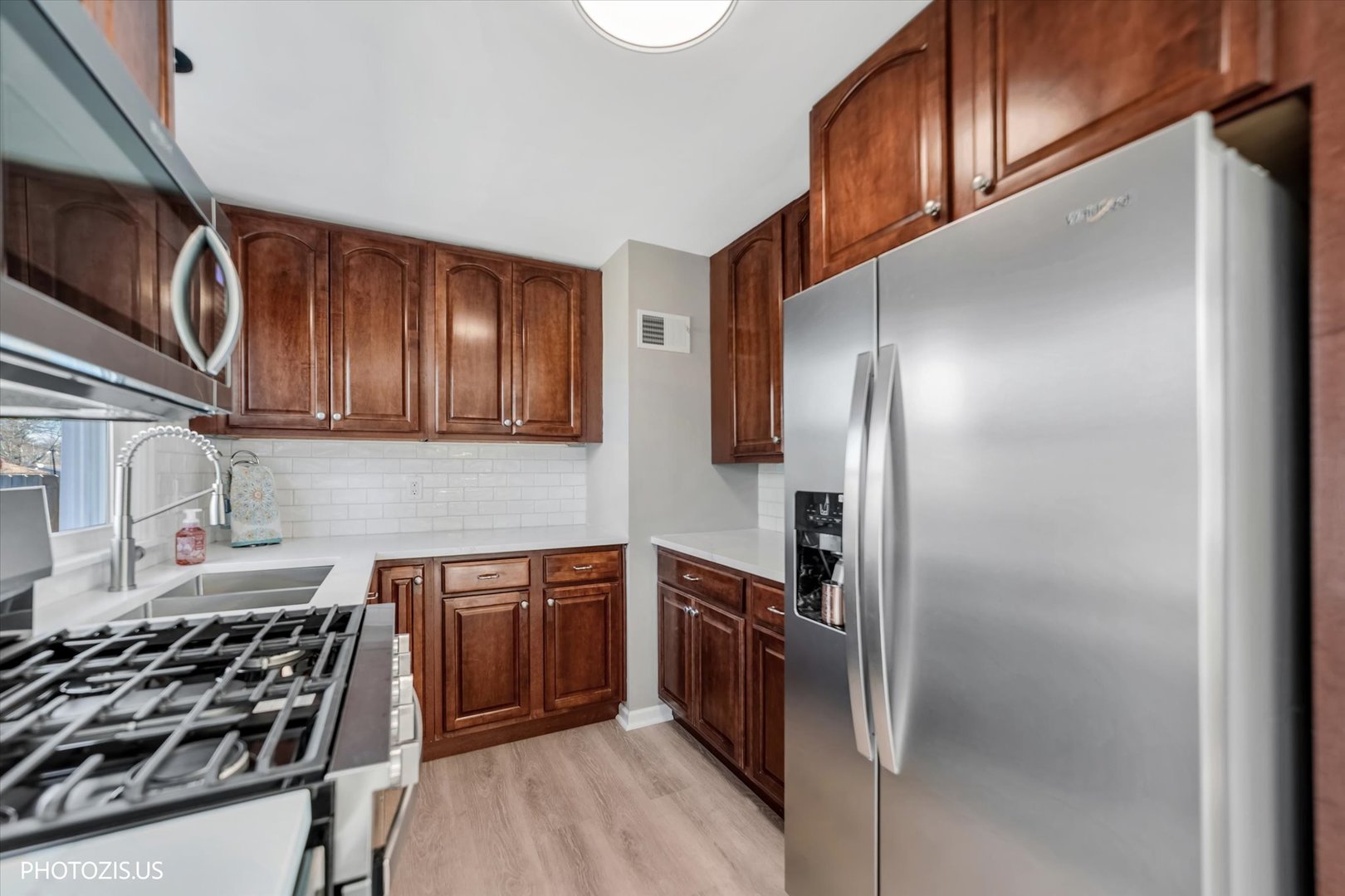 112 Pearl Street Cary, IL 60013 - Photo 7 of 25 a kitchen with stainless steel appliances a sink stove and refrigerator
