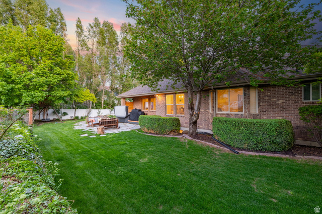 6208 West Bull River Road Highland, UT 84003 - Photo 82 of 90 Spacious backyard featuring a lush lawn, mature trees, and a flagstone patio