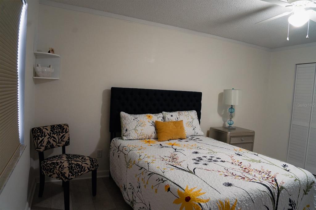 519 Albee Farm Road, Unit 110 Venice, FL 34285 - Photo 9 of 33 a bedroom with a bed and wooden floor
