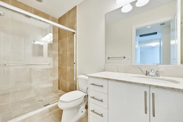 a bathroom with a sink toilet and shower