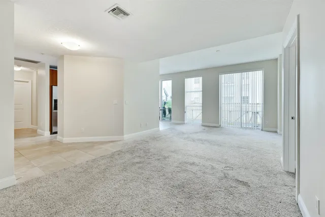 an empty room with windows and entrance