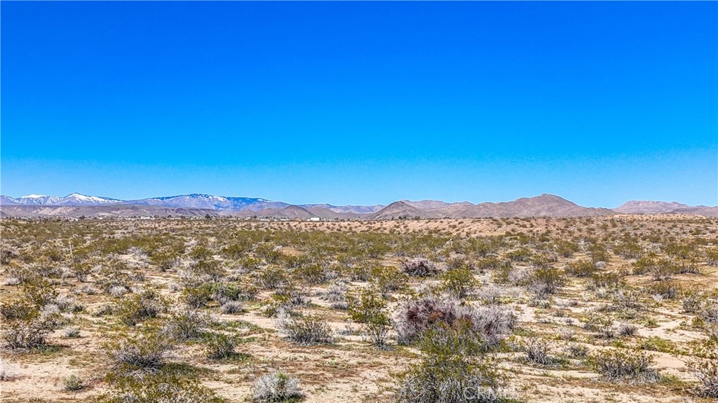 57645 Reche Road Landers, CA 92285 - Photo 18 of 38 a view of a mountain range in a cloudy sky
