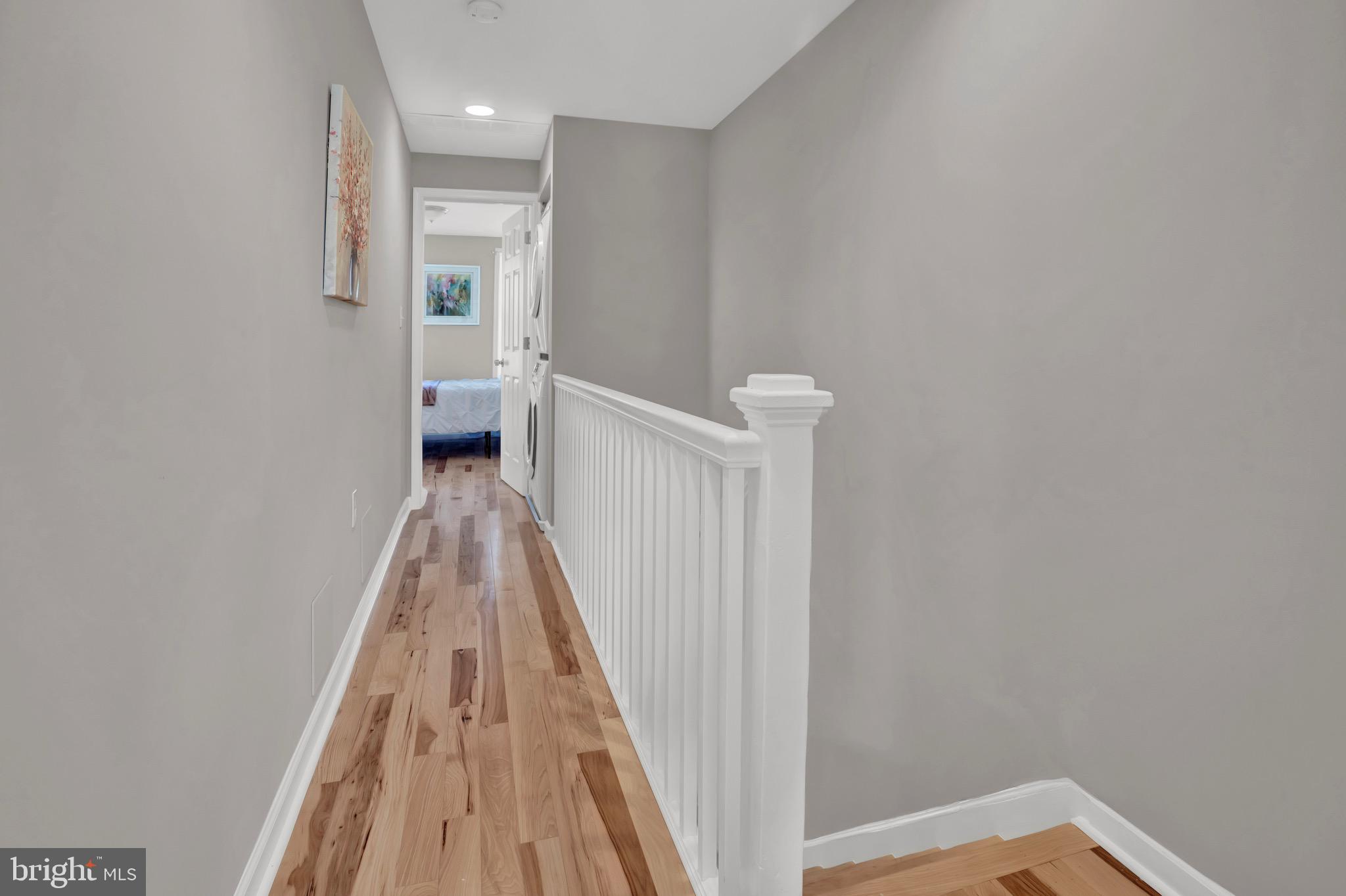 2111 East Chase Street Baltimore, MD 21213 - Photo 11 of 19 a view of a hallway with wooden floor and a bathroom