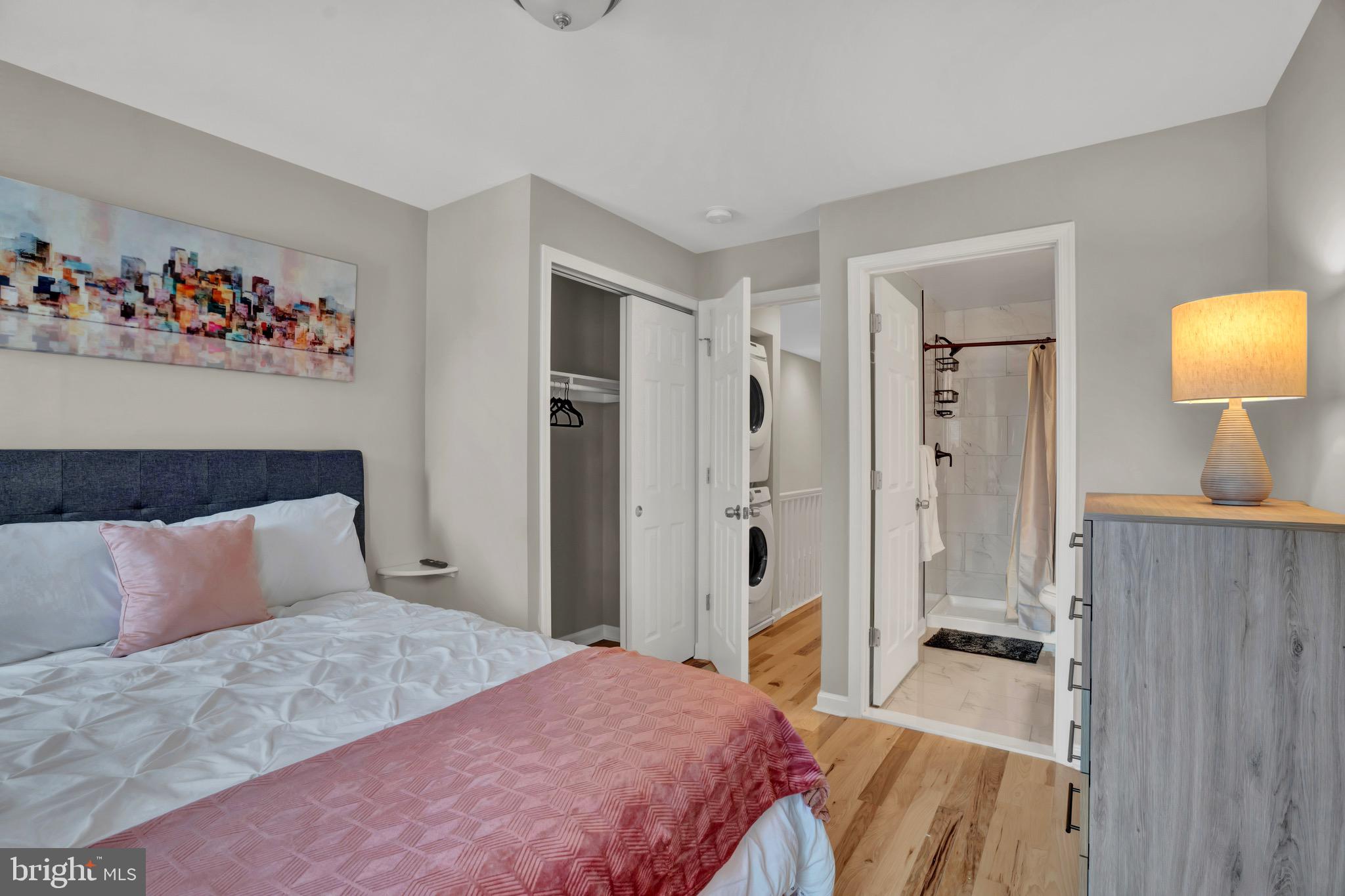 2111 East Chase Street Baltimore, MD 21213 - Photo 14 of 19 a bedroom with a bed and a lamp on dresser