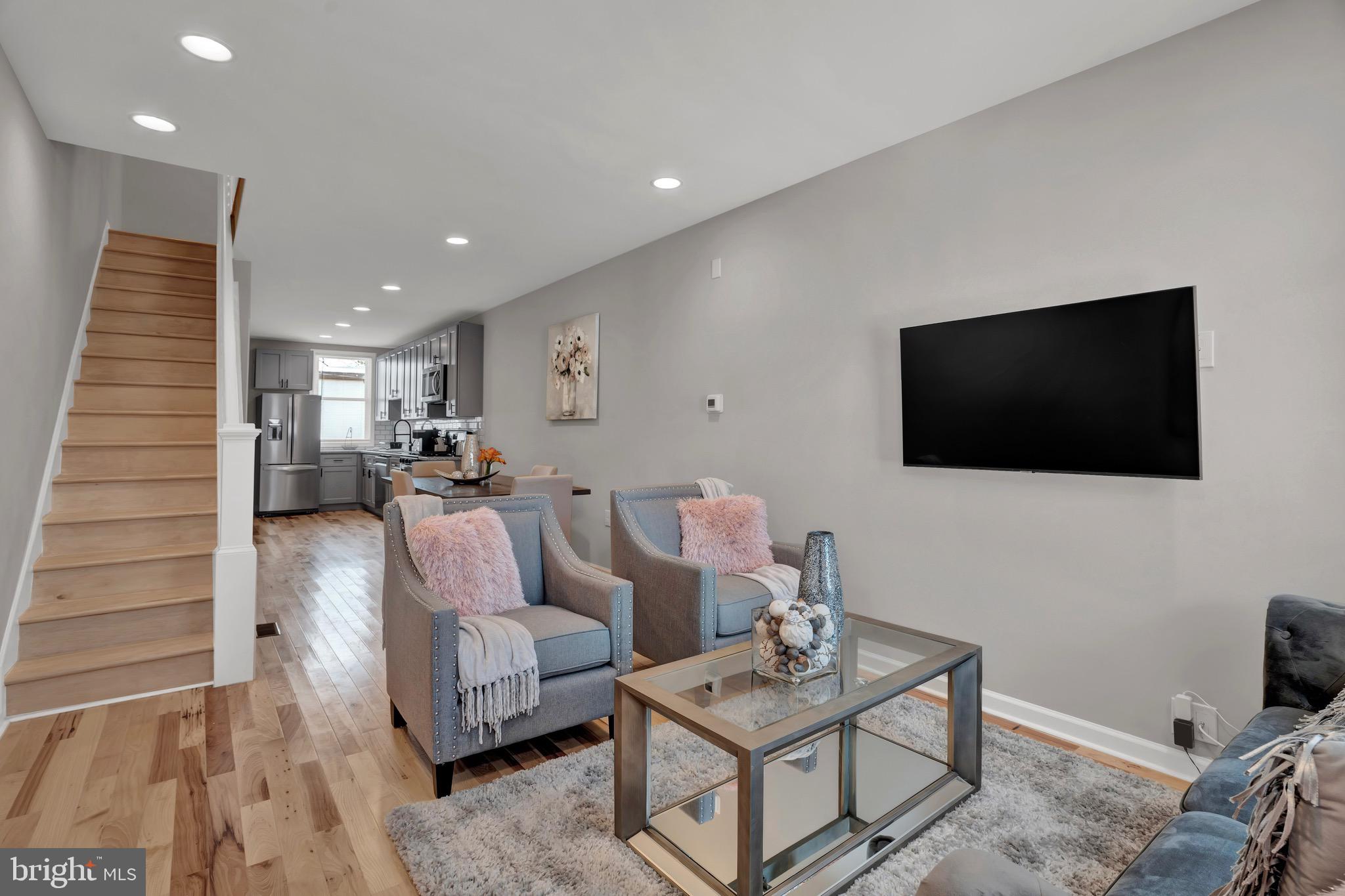 2111 East Chase Street Baltimore, MD 21213 - Photo 2 of 19 a living room with furniture and a flat screen tv